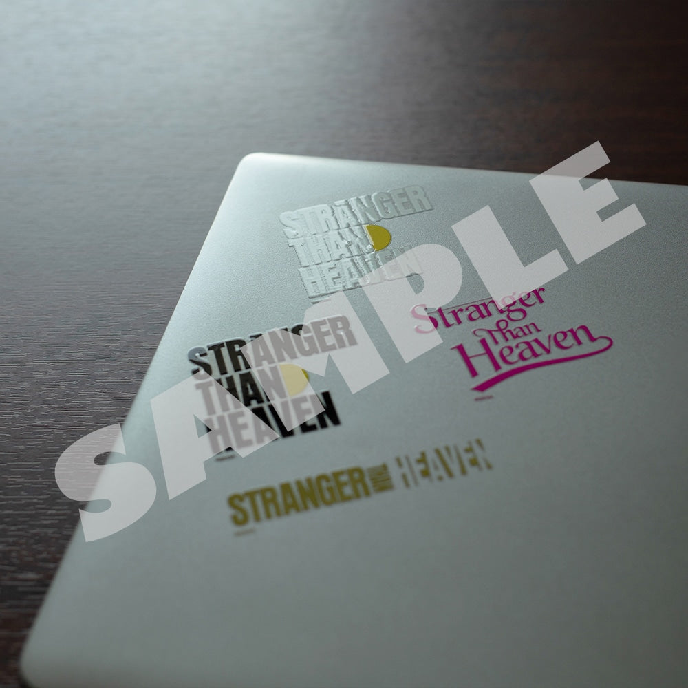 Four STRANGER THAN HEAVEN logo transfer stickers applied to a laptop